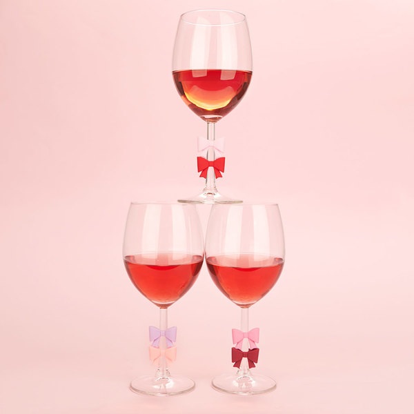 Balvi Marque-verres Coquette 6 marque-verres en forme de nœuds de différentes couleurs Plastique PVC